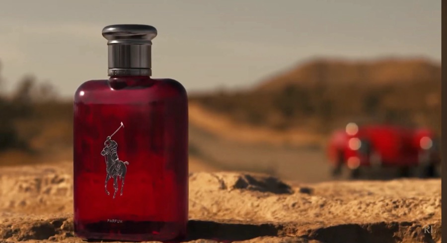 Polo Red bottle on desert rock, a red vintage car out of focus behind it