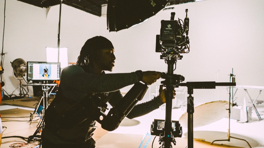 Anthony in silhouette with a Steadicam in a white studio