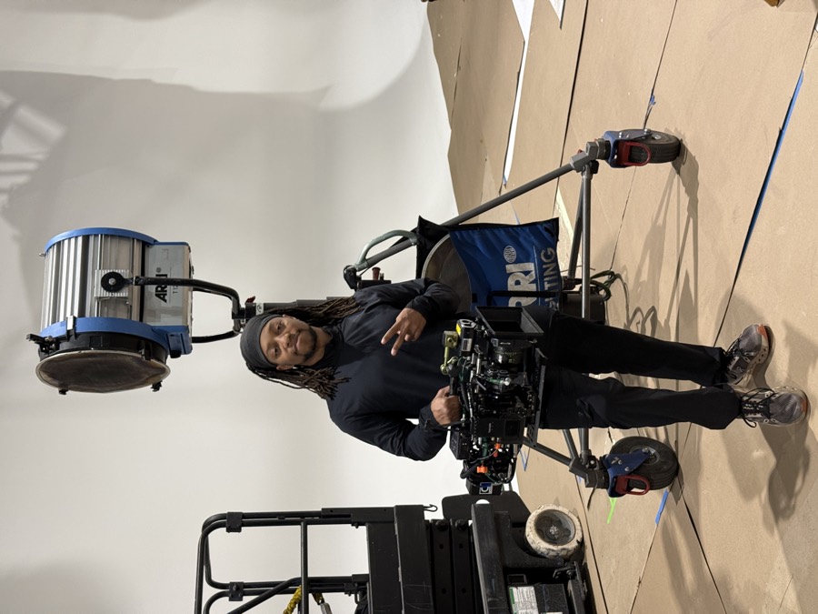 Anthony holding a Steadicam rig on a white studio set